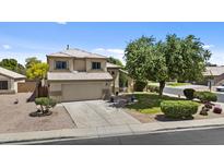 Two-story home with a two car garage, manicured lawn, and desert landscaping at 119 S Monterey St, Gilbert, AZ 85233