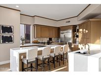 Gourmet kitchen featuring a large island with seating, modern cabinets, and stainless steel appliances at 18401 N 14Th St, Phoenix, AZ 85022