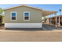 Charming single-story home with a covered carport and low-maintenance landscaping at 2060 N Center St # 138, Mesa, AZ 85201