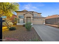 Attractive two-story home featuring manicured landscaping, neutral tones, and an attached two-car garage at 2206 S 114Th Ln, Avondale, AZ 85323