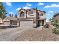 Charming two-story home featuring a two-car garage and low maintenance landscaping with ample parking at 2412 W Camp River Rd, San Tan Valley, AZ 85144
