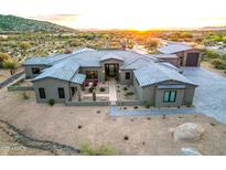 Stunning luxury home featuring desert landscaping, tile roof, and gray painted stucco at 31226 N Granite Reef Rd, Scottsdale, AZ 85266