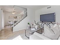 Bright living room with staircase, modern decor, and comfortable seating arrangement at 3511 E Baseline Rd # 1214, Phoenix, AZ 85042