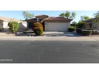 Charming home featuring a well-maintained front yard with desert landscaping and a two-car garage at 4613 E Walnut Rd, Gilbert, AZ 85298