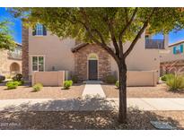Inviting two-story townhome with stone accents and a landscaped front yard at 4752 E Portola Valley Dr # 103, Gilbert, AZ 85297