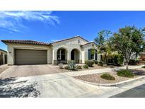 Charming single-story home featuring a tile roof, arched entryway, and well-maintained front yard landscaping at 5304 S Wesley S Cir, Mesa, AZ 85212