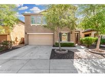 Charming two-story home featuring an attached two-car garage and a meticulously landscaped front yard at 5423 W Yearling Rd, Phoenix, AZ 85083
