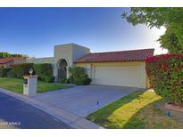 Charming single-story home with a red tile roof, arched entry, and well-manicured landscaping at 5718 N 72Nd Pl, Scottsdale, AZ 85250