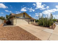 Charming home with two-car garage, desert landscaping and front yard fire hydrant at 7302 W Meadowbrook Ave, Phoenix, AZ 85033