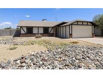 Charming single-story home with a neutral color scheme and a spacious two-car garage at 8571 N 83Rd Dr, Peoria, AZ 85345