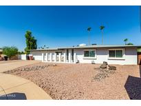 Charming single-story home featuring a two car garage and a desert landscape at 8714 E Mackenzie Dr, Scottsdale, AZ 85251