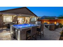 Inviting backyard with a modern hot tub, outdoor kitchen, and seating area perfect for entertaining at 12269 E Chiricahua Pl, Gold Canyon, AZ 85118
