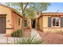 Charming single-Gathering home with a stone front door and landscaped front yard at 22815 N Arrellaga Dr, Sun City West, AZ 85375