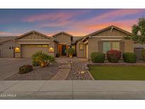 Inviting single-story home with well-manicured landscaping and a charming walkway at dusk at 3552 E Dogwood Dr, Chandler, AZ 85286