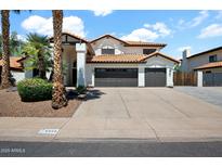 Charming two-story home featuring a three-car garage, well-maintained landscaping, and a classic tile roof at 5406 E Charleston Ave, Scottsdale, AZ 85254