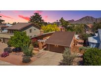 Charming home with beautiful landscaping and desert foliage, all set against a mountain backdrop at sunset at 5528 E Virginia Ave, Phoenix, AZ 85008