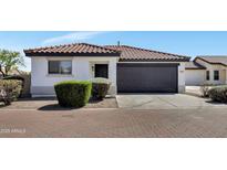 Charming single-story home featuring a dark garage door and low maintenance desert landscaping at 6108 S Wilson Dr, Chandler, AZ 85249