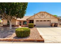 Charming single-Gathering home featuring a well-manicured front yard and a two-car garage at 7515 W Sweetwater Ave, Peoria, AZ 85381