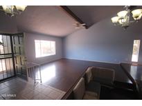 Bright living room features vaulted ceilings, hardwood floors, and large windows at 8310 N 49Th Ave, Glendale, AZ 85302