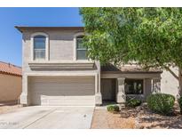 Charming two-story home featuring a well-maintained yard, mature tree, and a two-car garage at 852 E Mountain View Rd # 18, San Tan Valley, AZ 85143