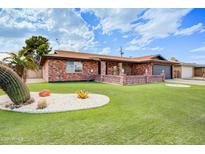 Charming brick home featuring manicured lawn and desert landscaping in a tranquil neighborhood setting at 858 S Portland --, Mesa, AZ 85206