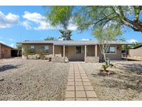 Charming single-story home featuring desert landscaping and a welcoming front porch at 9522 E Quarterline Rd, Mesa, AZ 85207