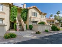Inviting condo exterior with desert landscaping and stairs leading to the second level at 9711 E Mountain View Rd # 2543, Scottsdale, AZ 85258