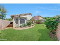 A backyard featuring lush green grass, garden beds and a privacy fence for outdoor enjoyment at 16036 N 11Th Ave # 1084, Phoenix, AZ 85023