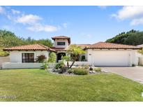 Charming single-story home with a red tile roof, lush lawn, and a well-manicured desert landscape at 3117 E Maryland Ave, Phoenix, AZ 85016