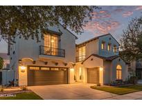 Beautiful two-story home featuring a two-car garage, balcony and Spanish-style architecture against a vibrant sunset sky at 4615 E Calistoga Dr, Gilbert, AZ 85297