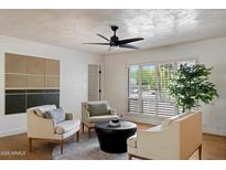 Bright living room with hardwood floors, modern lighting, comfortable seating, and large windows at 5701 E Charter Oak Rd, Scottsdale, AZ 85254