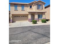 Two-story home with a two-car garage, tidy landscaping, and a classic tile roof at 9418 W Eaton Rd, Phoenix, AZ 85037