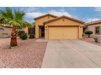 Inviting single-Gathering home featuring a two-car garage and desert landscaping at 16261 W Custer Ln, Surprise, AZ 85379