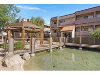 A charming community gazebo overlooks a serene pond, creating a peaceful and inviting outdoor space at 1645 W Baseline Rd # 2125, Mesa, AZ 85202