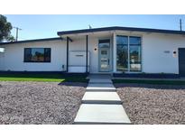 Charming single-story home with modern updates, a landscaped yard, and walkway at 1920 N Cavalier Dr, Tempe, AZ 85288