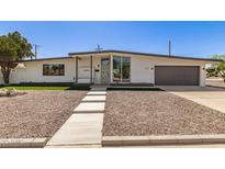 Beautiful single-story home featuring a modern design, gray accents, and a landscaped front yard at 1920 N Cavalier Dr, Tempe, AZ 85288