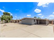 Charming single-story home featuring a large, paved driveway and desert landscaping under a bright, sunny sky at 2325 E Delgado St, Phoenix, AZ 85022
