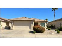 Charming single-story home with a well-manicured front yard and a two-car garage under a clear blue sky at 3454 E Bellerive Pl, Chandler, AZ 85249