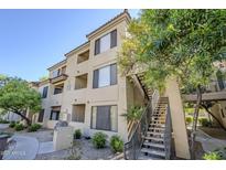 Beige two-story building with a stairwell and drought-resistant landscaping and a BBQ at 4925 E Desert Cove Ave # 326, Scottsdale, AZ 85254