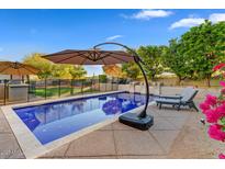 Relaxing pool area with lounge chairs, umbrellas and BBQ area, perfect for outdoor entertaining at 9087 E Mountain Spring Rd, Scottsdale, AZ 85255