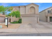 Two story home featuring a two car garage, neutral exterior paint, and desert landscaping at 12841 W W . Via Camille --, El Mirage, AZ 85335