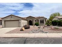 Charming single-story home with desert landscaping and a two-car garage at 15158 W Camino Estrella Dr, Surprise, AZ 85374