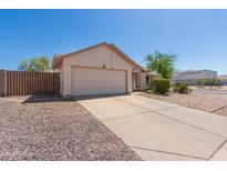 Traditional home with neutral siding, desert landscaping, a long driveway, and an attached two car garage at 2509 N Cheri Lynn Dr, Chandler, AZ 85225