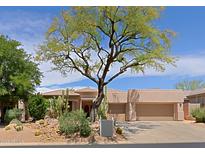 Charming single-story home featuring xeriscaping, a tile roof and a two-car garage at 6714 E Amber Sun Dr, Scottsdale, AZ 85266