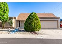 Charming single-story home featuring a low-maintenance yard, desert landscaping, and a two-car garage at 1207 E Sequoia Dr, Phoenix, AZ 85024