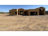 New home construction featuring wood framing and a spacious open floor plan with a two-car garage at 1244 E Smokehouse Trl, Phoenix, AZ 85085