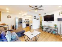 Bright living room with stainless steel appliances, sleek furniture, and an open floor plan at 3002 N 70Th St # 120, Scottsdale, AZ 85251