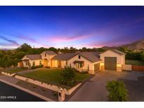 Stunning single-story home showcasing a well-manicured front yard and neutral color palette against a twilight sky at 3981 E Runaway Bay Pl, Queen Creek, AZ 85142
