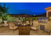Inviting outdoor patio with comfortable seating, a dining table, a grill, and lush landscaping at 4200 E Narrowleaf Dr, Gilbert, AZ 85298