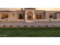 Beautiful home exterior featuring a manicured lawn and a grand arched entryway, exuding elegance and curb appeal at 6633 E Horseshoe Rd, Paradise Valley, AZ 85253